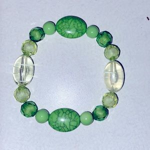 Small green and clear elastic beaded bracelet